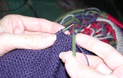 Slip the first stitch on the row off the left knitting needle onto the right knitting needle without knitting it