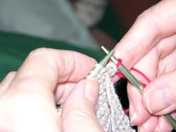 Slip the old stitch off the left knitting needle by pulling the right hand needle to the right.