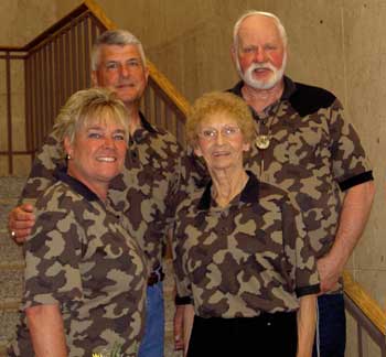 Bob and Betty Fratzke stand up for Scott and Lori Smolen at their wedding, all dressed in Fratzke Camo Wear