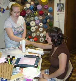 Danielle shows Shastina how to quickly dry the paint with a hair dryer